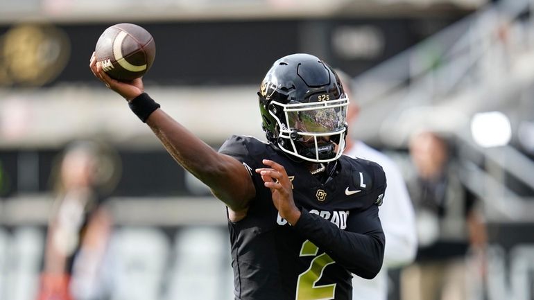 Colorado quarterback Shedeur Sanders warms up before an NCAA college...