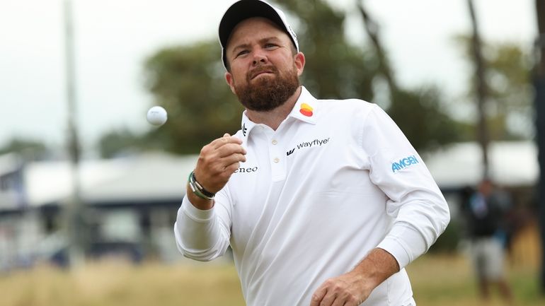 Shane Lowry of Ireland throws his ball into the stands...