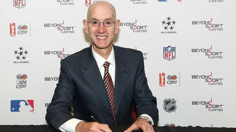 NBA Commissioner Adam Silver signs the Commissioners Letter, a joint...