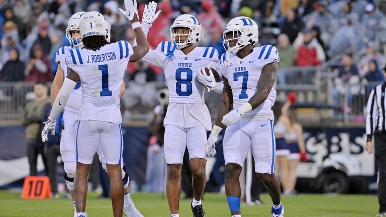 Duke wide receiver Jordan Moore (8) is congratulated by wide...