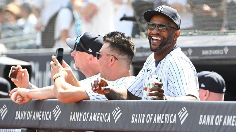 The Yankees’ CC Sabathia looks on from the dugout during...