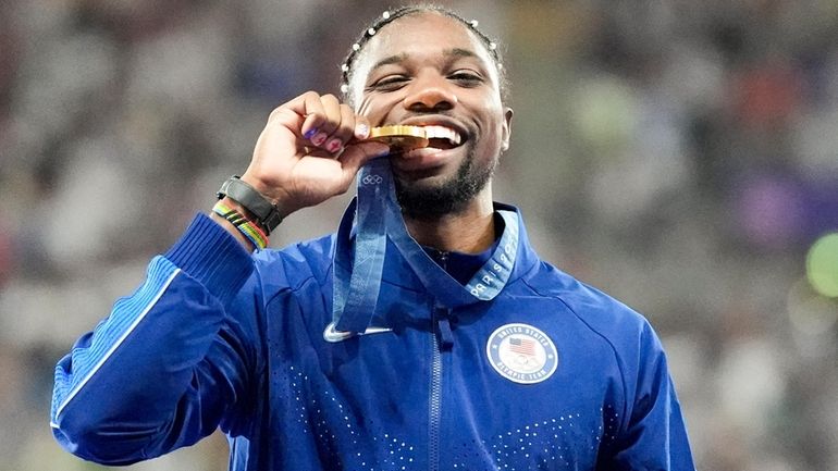 Gold medalist, Noah Lyles, of the United States, poses on...