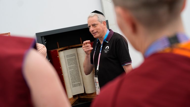 Rabbi Moshe Lewin shows the Torah to buddhist monks in...