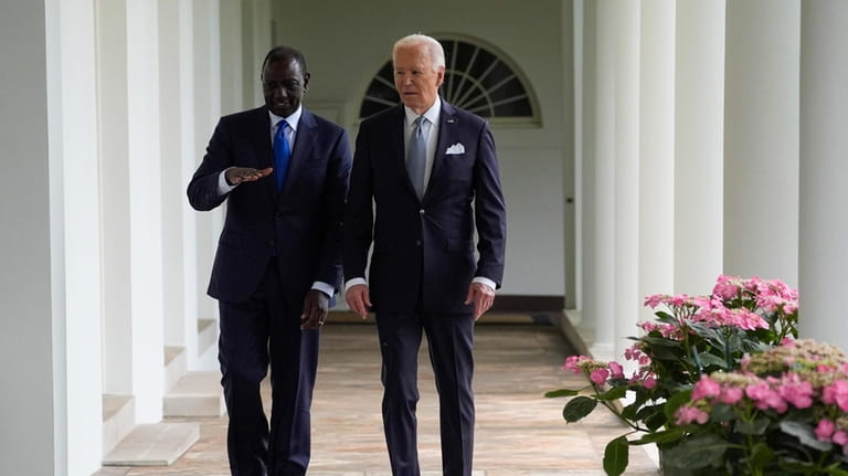 President Joe Biden and Kenya's President William Ruto walk along...