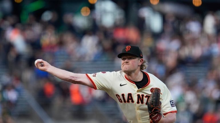 San Francisco Giants pitcher Logan Webb throws to an Oakland...