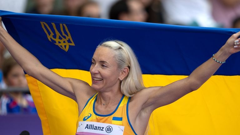 Oksana Zubkovska, of Ukraine, celebrates after winning the Women's Long...