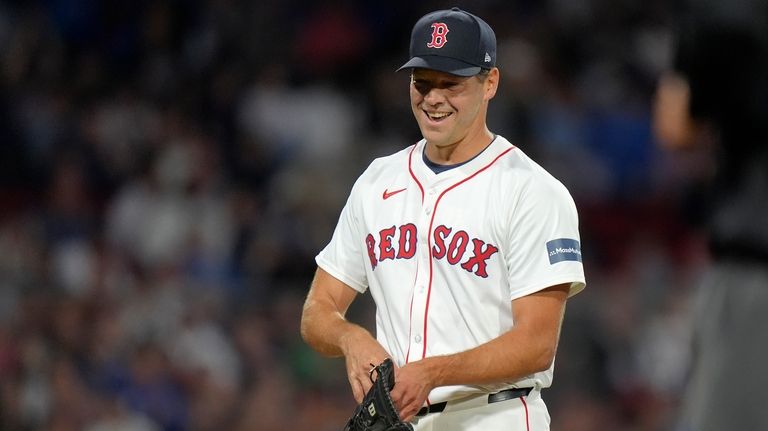 Boston Red Sox pitcher Rich Hill steps off the mound...