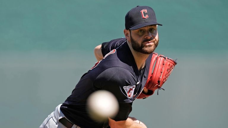 Cleveland Guardians starting pitcher Lucas Giolito throws during the first...