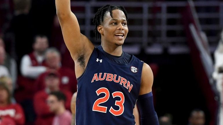 Auburn's Isaac Okoro celebrates after Auburn defeated Arkansas 79-76 in overtime...