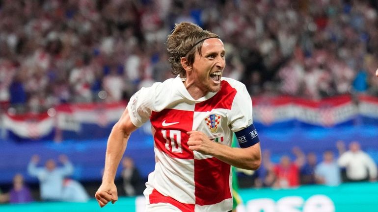 Croatia's Luka Modric celebrates after scoring his side's opening goal...