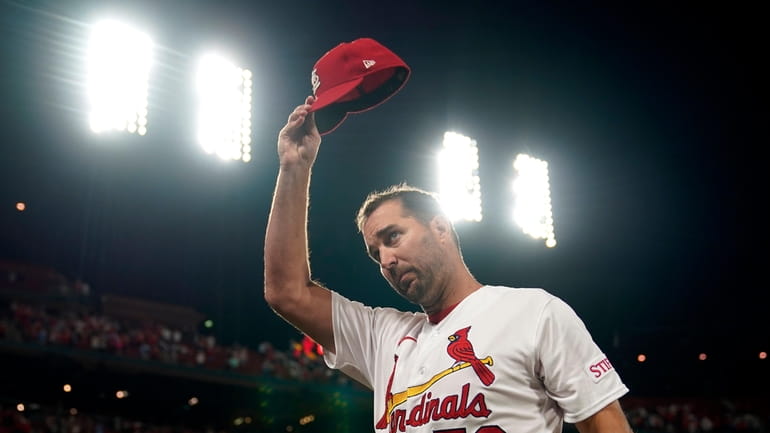 ;St. Louis Cardinals starting pitcher Adam Wainwright tips his cap...