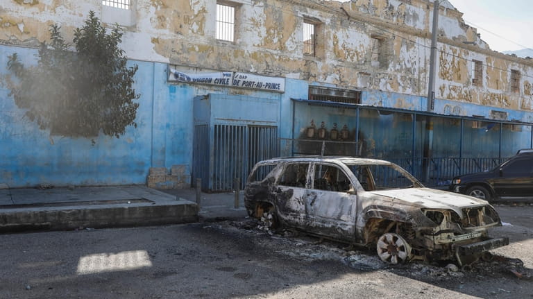 A burned car is seen outside the National Penitentiary in...