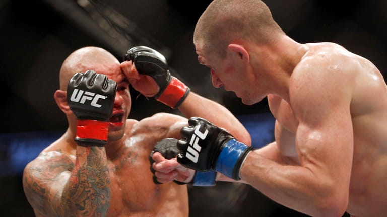 Thiago Alves, left, and Seth Baczynski fight in a mixed...