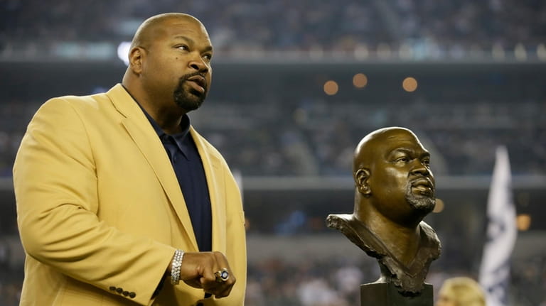 Dallas Cowboys Hall of Fame Inductee Larry Allen shows off...