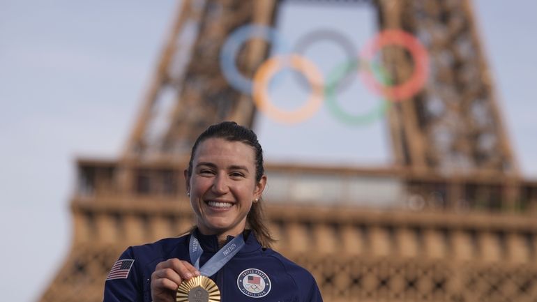 Kristen Faulkner, of the United States, poses with the gold...