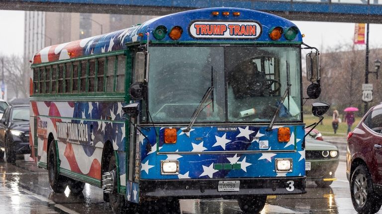 A bus painted as the Trump Train pulls up outside...