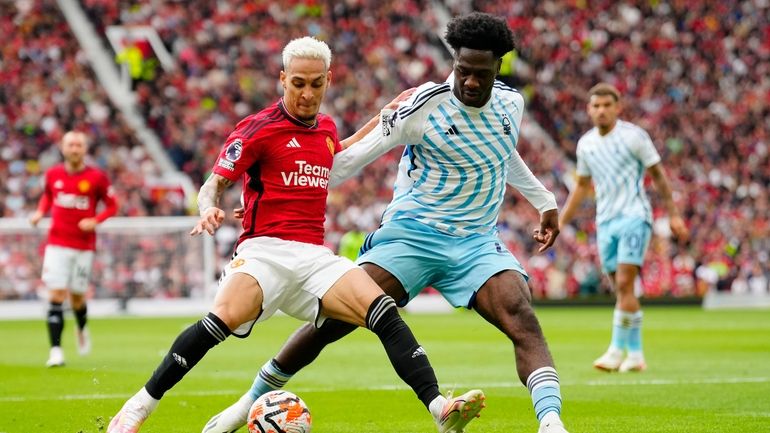 Manchester United's Antony, left, challenges for the ball with Nottingham...