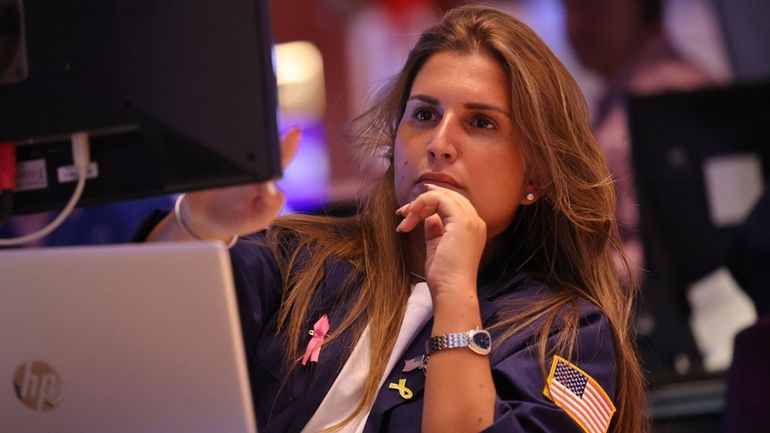 A trader on the floor of the New York Stock...