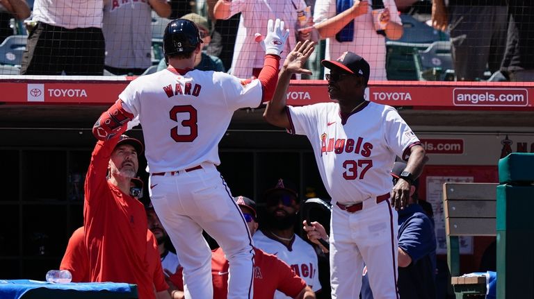 Los Angeles Angels' Taylor Ward (3) celebrates his grand slam...