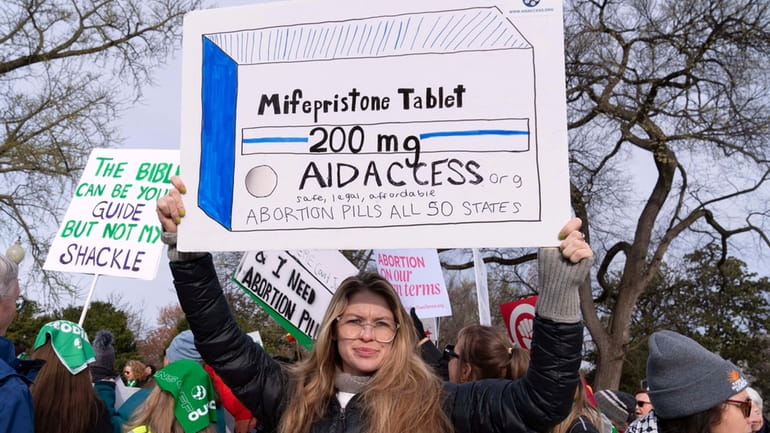 Abortion-rights activists protest in March outside the Supreme Court in...