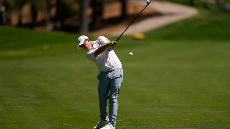 Matt Fitzpatrick, of England, hits from the 14th fairway during...