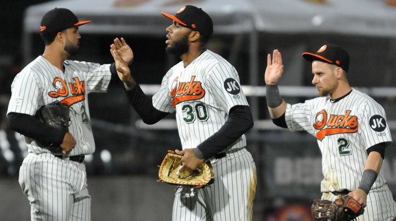 David Washington of the Long Island Ducks, center, celebrates with...