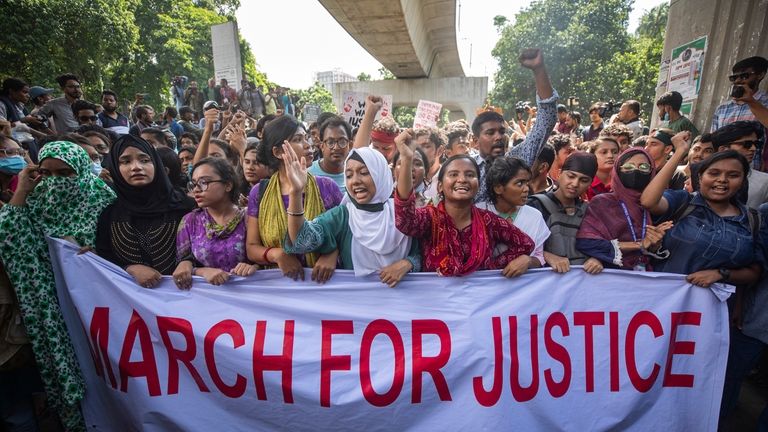 FILE- University students shout slogans during a protest to demand...