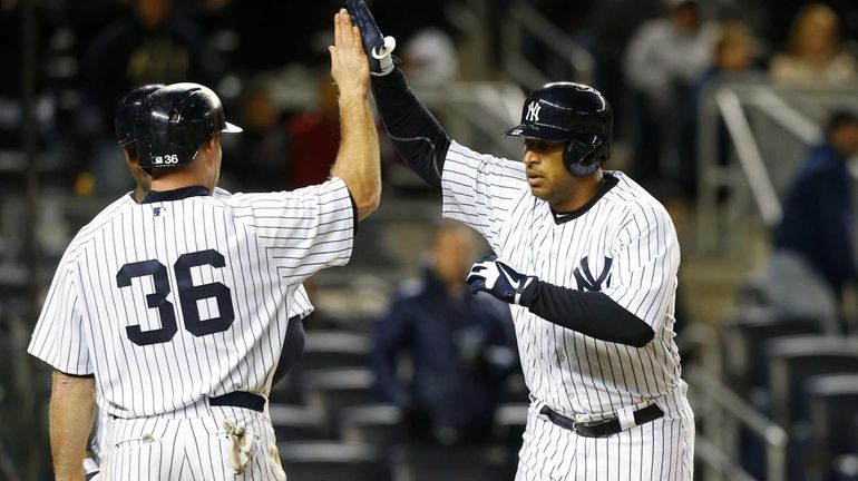 Vernon Wells celebrates his eighth inning three-run home run with...