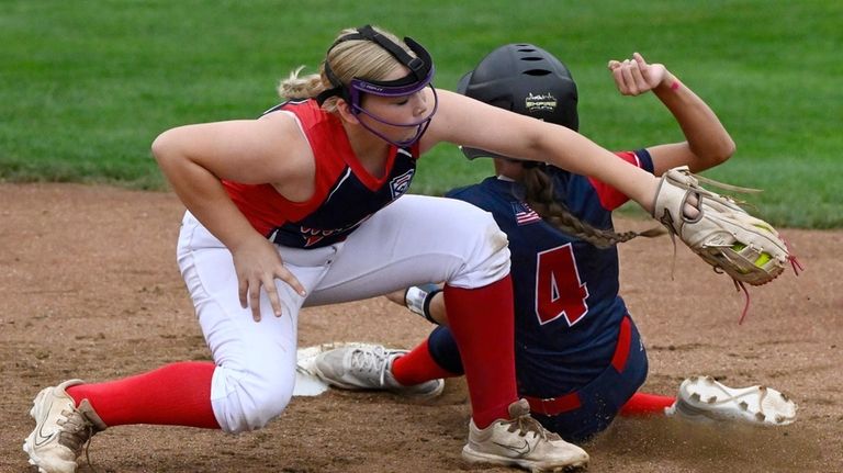 Massapequa International's Avery Smar avoids the tag from Middletown Delaware's...