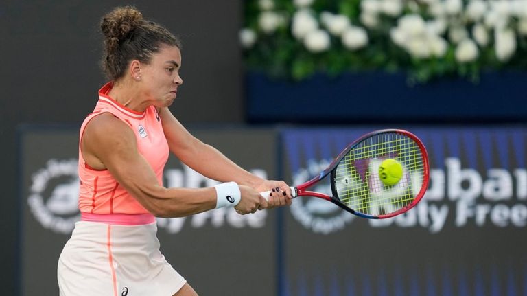 Jasmine Paolini of Italy returns the ball to Solana Cirstea...