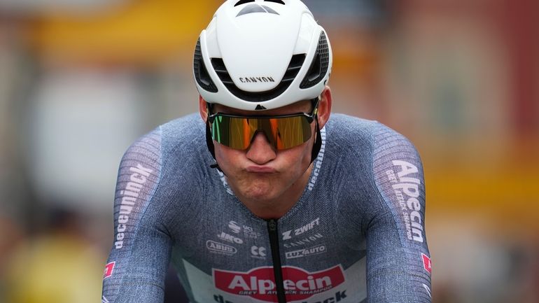 Netherlands' Mathieu van der Poel reacts after crossing the finish...