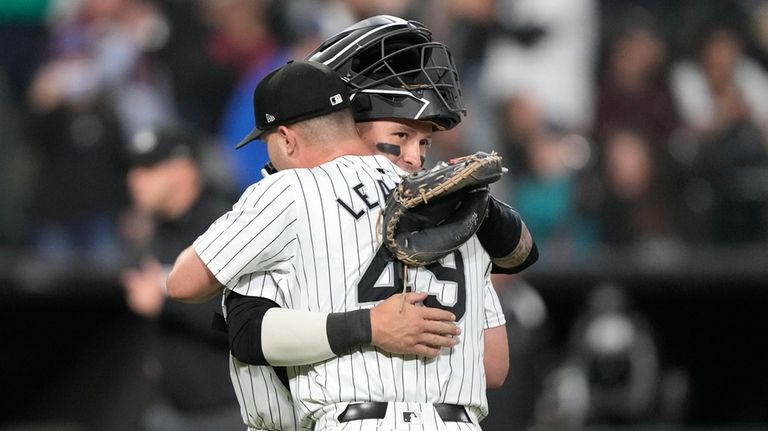 Chicago White Sox catcher Korey Lee, rear, and teammate Jordan...