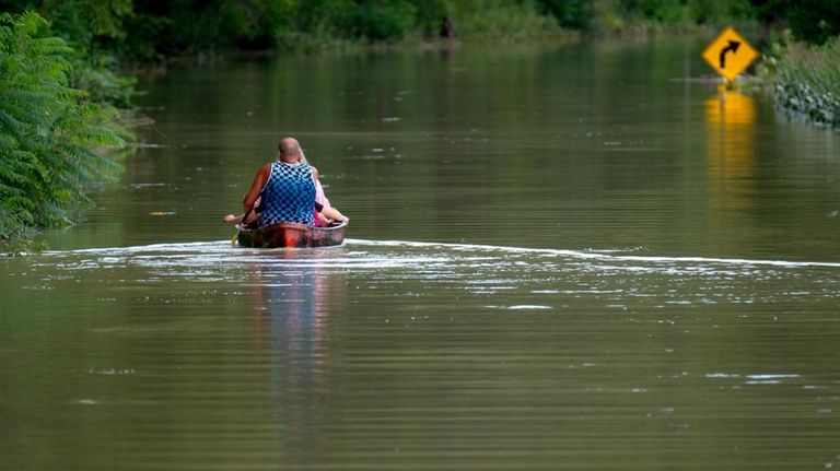 Eric Combs, Maverick Knight and Michelle Knight paddle away as...