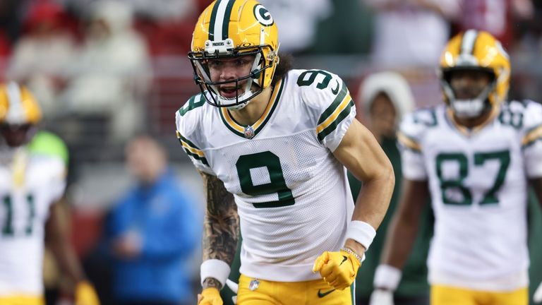 Green Bay Packers wide receiver Christian Watson warms up before...