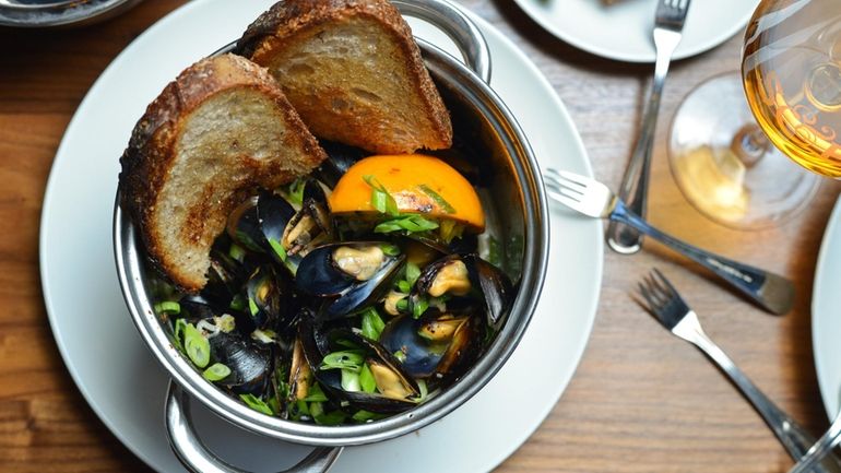 Prince Edward Island mussels swimming in bourbon, burnt orange, cream...