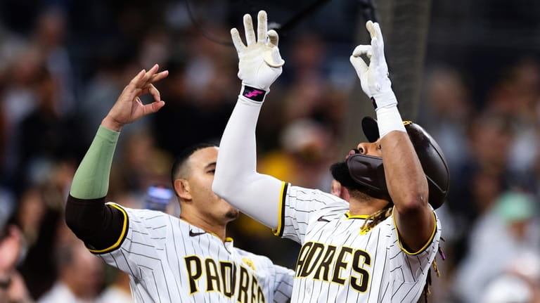 San Diego Padres' Fernando Tatis Jr., right, celebrates with Manny...