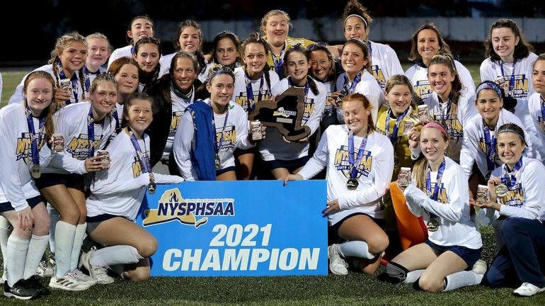 Northport girls field hockey team pose with the winners plaque,...