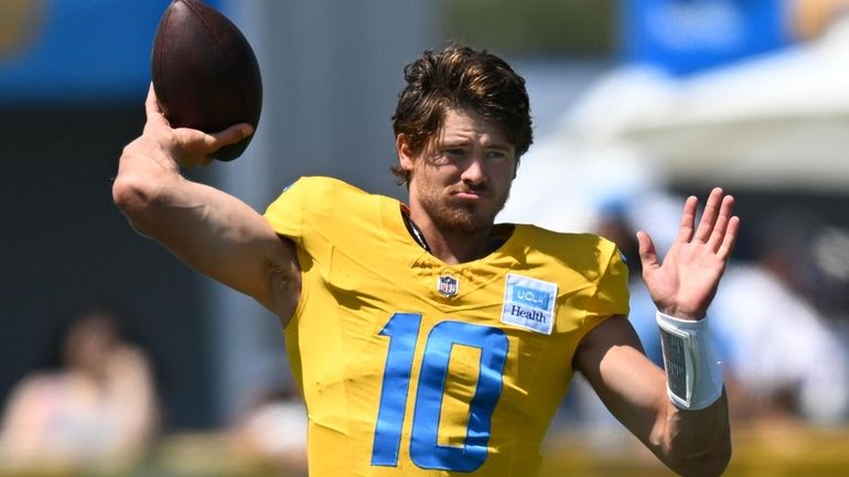 Los Angeles Chargers quarterback Justin Herbert warms up during NFL...