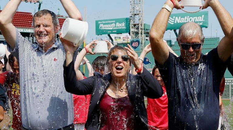 Boston Red Sox president and CEO Sam Kennedy, left, Massachusetts...