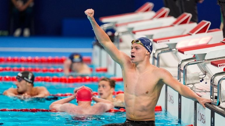 Leon Marchand, of France, celebrates after winning the men's 400-meter...