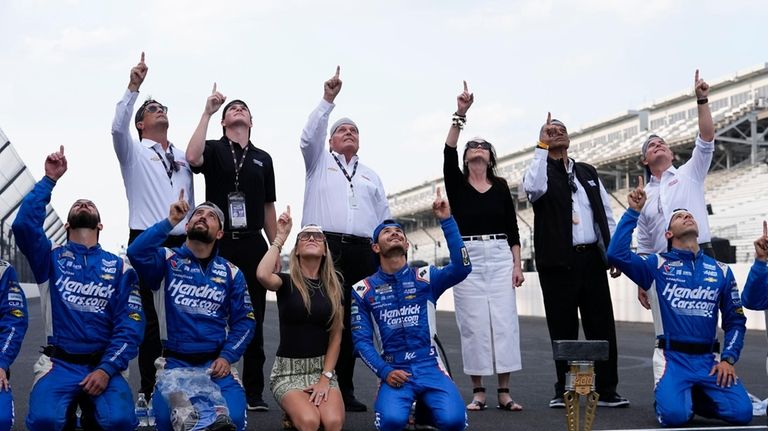 Kyle Larson, fourth from bottom left, celebrates with his crew...