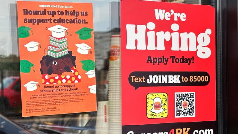 A hiring sign is displayed at a restaurant in Wheeling,...