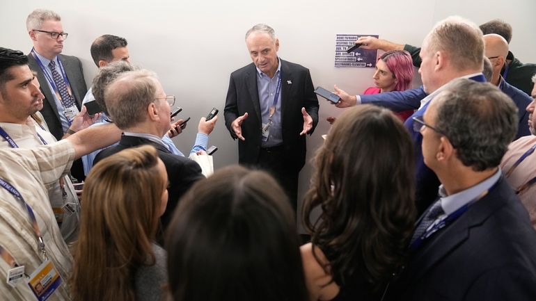 Major League Baseball Commissioner Rob Manfred talks with reporters before...