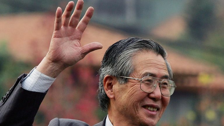 Former Peru's President Alberto Fujimori waves at his home in...