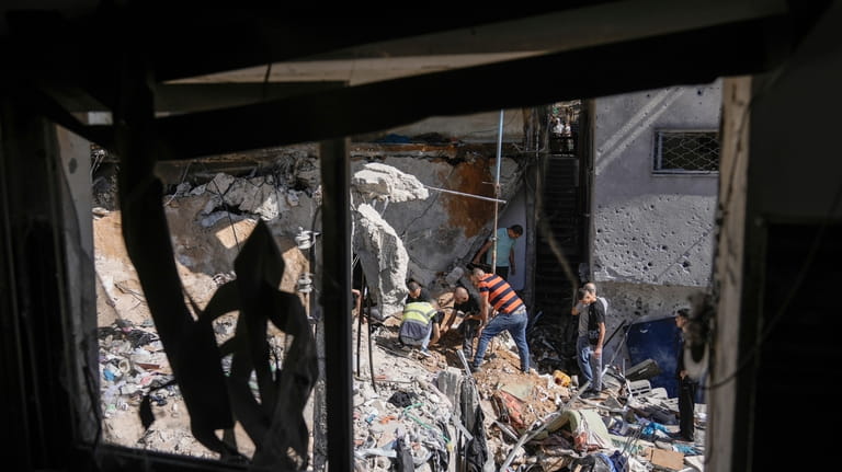 Palestinians inspect the destruction following an Israeli operation in Nur...