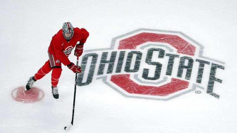 Ohio State University forward Ronnie Hein guides the puck during...