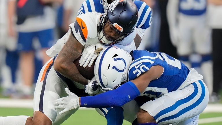 Denver Broncos wide receiver Tim Patrick (12) carries the ball...