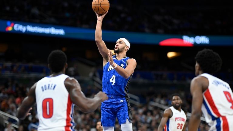 Orlando Magic guard Jalen Suggs (4) goes up to shoot...