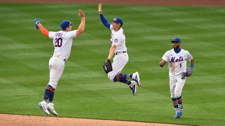 Mets players Pete Alonso, Brandon Nimmo and Amed Rosario celebrate their...