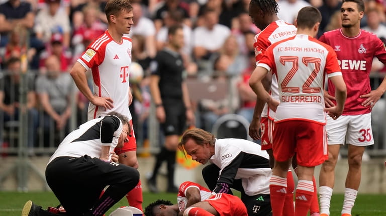Injured Bayern's Kingsley Coman grimaces in pain during the German...